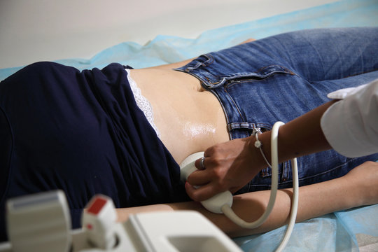 Ultrasonic examination of internal organs in a young girl.