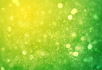 Green and Yellow sparkle rays lights with bokeh elegant abstract background. Dust sparks in explosion background. Vintage or retro.