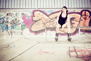 Fototapeta na wymiar Young Woman With Inline Skates
