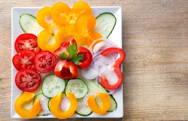 Fresh sliced vegetable salad on a white plate