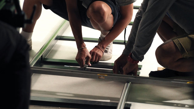 Behind the scenes of production team setting dolly track.