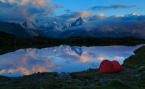 Red tent at Lac des Cheserys in the mountains near Chamonix during dusk. Chamonix, France