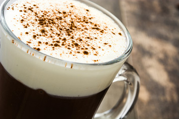 Irish coffee in glass on wooden table
