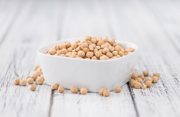 Dried Chickpeas on wooden background; selective focus