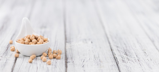 Dried Chickpeas on wooden background; selective focus