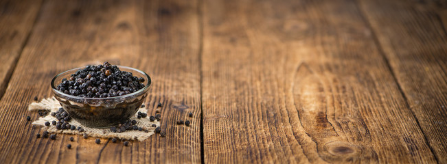 Wooden table with preserved black Peppercorns