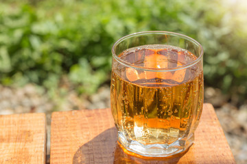 Lemonade in glass on the table outdoor on natural background