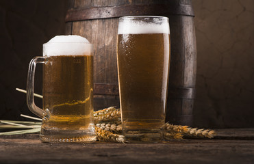 Beer barrel with beer glass on table on wooden background