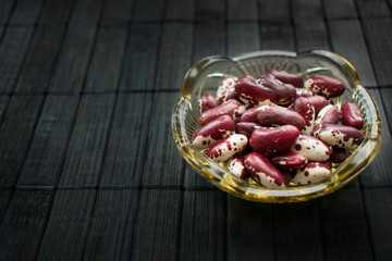 Red beans in a crystal dish close up. Benefits for diet, weight control and diabetes. Health Benefits of Beans.