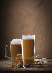 Beer barrel with beer glass on table on wooden background