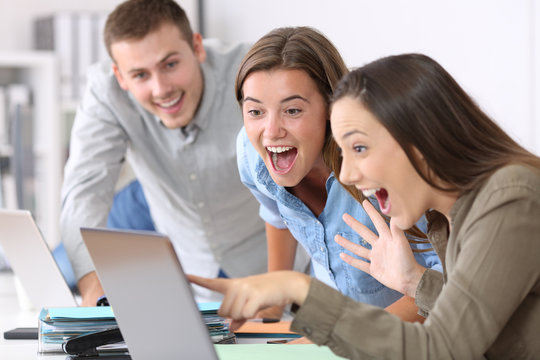 Three excited employees receiving good news