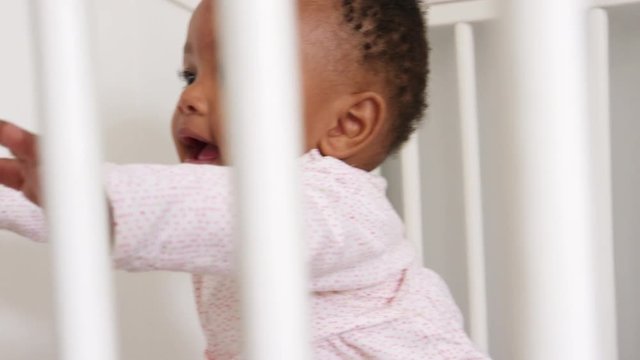 Happy Baby Girl Playing In Nursery Cot Shot In Slow Motion