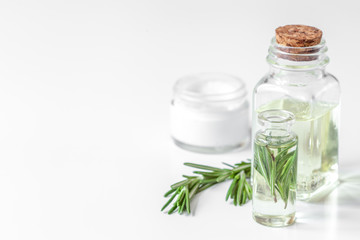 organic cosmetics with extracts of herbs rosemary on white backg