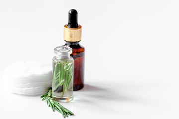 organic cosmetics with extracts of herbs rosemary on white backg