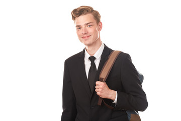 Studio portrait of teenage college student in black suit posing against white background