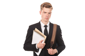 Studio portrait of teenage college student in black suit posing against white background