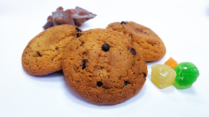 Oatmeal cookies with chocolate chips. Pieces of lucum and chocolate with hazelnuts. Close-up.
