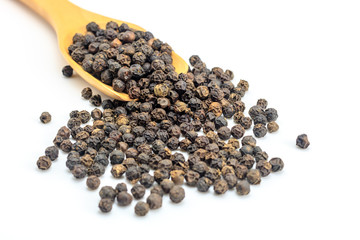 Peppercorn with wooden spoon on white background. Composition isolated over the white background.