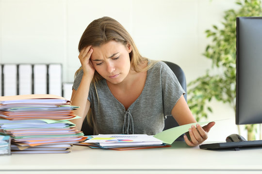 Worried Employee Reading Report At Office