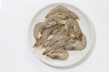 Raw shrimp in a plate isolated on the white backgorund.