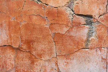Surface of an old red cracked wall