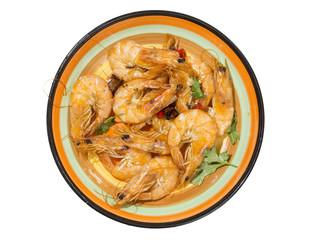 Delicious seafood shrimp with red pepper, coriander and olive oil made, and in a colorful  plate.