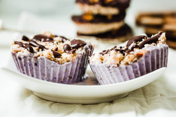 Raw vegan nuts dessert with blueberries, coconut and chocolate.Healthy lifestyle and food concept.