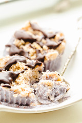 Raw vegan nuts dessert with blueberries, coconut and chocolate.Healthy lifestyle and food concept.