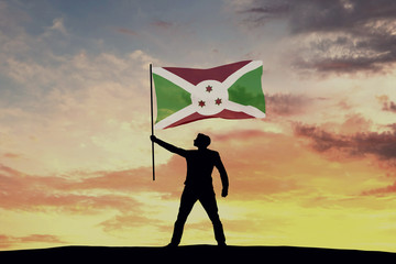 Male silhouette figure waving Burundi flag. 3D Rendering