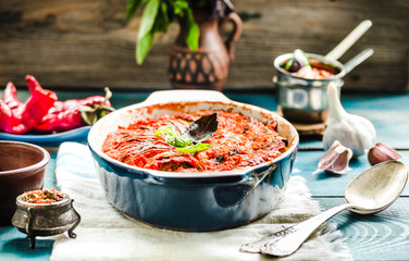 Ratatouille on rustic background, baked vegetables in tomato sauce with basil and paprika