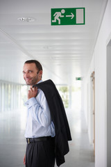 Fototapeta premium Businessman in an empty office, smiling
