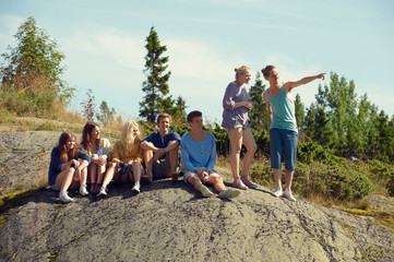 Friends sitting together on boulder
