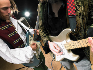 Fototapeta na wymiar Two electric guitar players in studio.