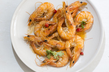 Delicious seafood shrimp with red pepper, coriander and olive oil made,  and in the plate.
