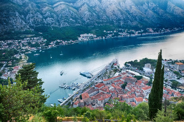 old mediterranean town and bay of Kotor city late afternoon - sail boats, ships on water, tones