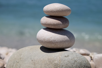 stack of pebbles balance harmony zen - ocean or sea shore, refreshing blue waves summer, beach
