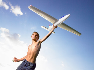 Young boy ready to send off an airplane