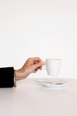 Older woman's hand holding cup