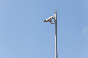 Security camera on the blue sky background