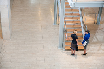 Businesswomen by stairwell