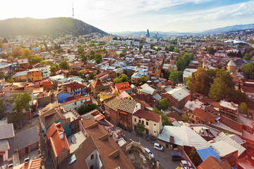 Tbilisi, old part of town with cobbled pavement and antique buildings. Panorama view from cable...
