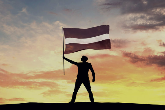 Male silhouette figure waving Latvia flag. 3D Rendering