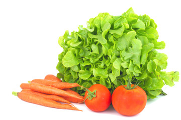 Real organic vegetables carrots, green salad, tomatoes isolated on white background