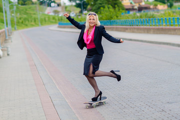 Senior business woman having fun on a skateboard outdoors. The concept of moving forward.