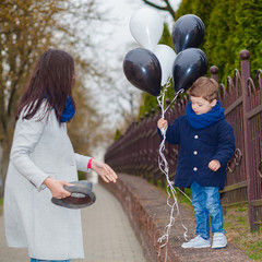 Portrait of fashionable baby boy and his gorgeous mother. little boy hugs his mother emotionally.