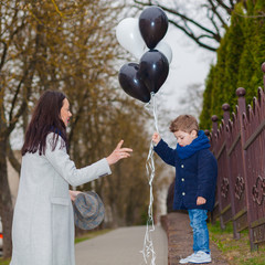 Portrait of fashionable baby boy and his gorgeous mother. little boy hugs his mother emotionally.