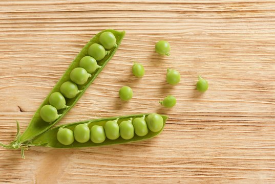 fresh peas on wooden background