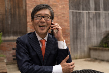 Asian businessman talking on a cell phone
