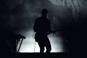 Silhouette of a guitar player in stage lights