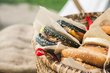 Fresh hamburgers in basket, closeup shot, selective focus